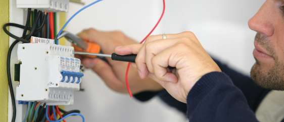 homme effectuant une intervention sur une armoire électrique